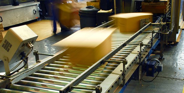 Corrugated boxes moving through an automated packaging line